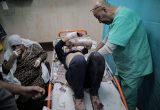 An injured child being treated by health workers at the Al-Aqsa Martyrs Hospital in Gaza